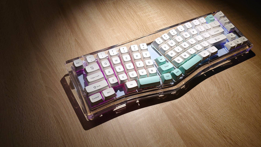 A photo shows the X-Bows Crystal Ergonomic Keyboard on a wood-grain desktop.