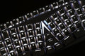 Angled close-up of black X-Bows Lite ergonomic mechanical keyboard featuring illuminated white LED backlighting across radial-columnar layout.